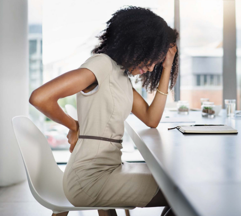 Woman Sitting in Office Chair Tired and Feeling Back Pain.