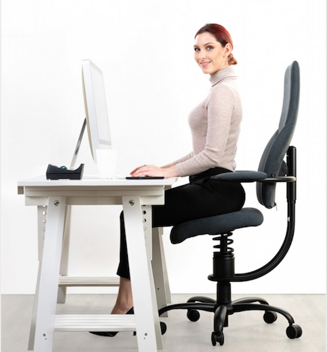 Woman Sitting In the Grey Spinalis Active Office Chair, energetic, fresh and without back pain. 
